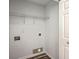 Small laundry room with overhead storage and white door at 5033 Thornton Dr, Summerville, SC 29485