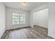 Open-concept room featuring luxury vinyl plank flooring, white walls, and a large window, offering ample natural light at 5033 Thornton Dr, Summerville, SC 29485