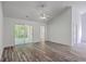 Spacious living area with luxury vinyl plank flooring, a ceiling fan, and a glass door leading to the backyard at 5033 Thornton Dr, Summerville, SC 29485