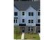 New construction townhouse with black shutters and sidewalk to the covered entry at 5108 Double Eagle Lp, Summerville, SC 29485