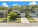 Aerial view of a well-maintained home with a spacious yard, lush trees, and a driveway leading to a two-car garage at 529 Beverly Dr, Summerville, SC 29485
