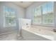 Bright bathroom features a soaking tub with marble flooring and large windows that provide ample natural light at 529 Beverly Dr, Summerville, SC 29485