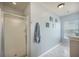 Neutral bathroom featuring a walk-in shower with glass door, marble tile flooring, and a window for natural light at 529 Beverly Dr, Summerville, SC 29485