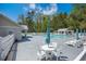 Community pool area features a clear pool, lounge chairs, umbrellas, and tables for residents to relax and enjoy at 529 Beverly Dr, Summerville, SC 29485
