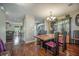 Elegant dining room with hardwood floors, a stylish chandelier, and a classic china cabinet with decorative dishware at 529 Beverly Dr, Summerville, SC 29485