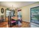 Bright dining room with a view of the front yard and a decorative china cabinet showcasing fine dishware at 529 Beverly Dr, Summerville, SC 29485