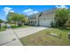 Two-story home with a manicured lawn, a spacious driveway leading to an attached garage, and a welcoming front porch at 529 Beverly Dr, Summerville, SC 29485