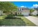 Charming two-story home featuring a well-manicured lawn, lush landscaping, and inviting front porch at 529 Beverly Dr, Summerville, SC 29485