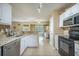 Well-lit kitchen features granite countertops, stainless steel dishwasher, and white cabinetry at 529 Beverly Dr, Summerville, SC 29485