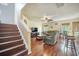 Cozy living room with hardwood floors, a comfortable sofa, a ceiling fan, and staircase access at 529 Beverly Dr, Summerville, SC 29485