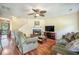 Comfortable living room featuring a fireplace, hardwood floors, and a large television for entertainment at 529 Beverly Dr, Summerville, SC 29485