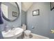 Stylish powder room with a decorative mirror and blue walls at 529 Beverly Dr, Summerville, SC 29485