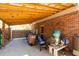 Exterior view of a backyard with a covered porch, brick siding, and outdoor storage solutions at 643 Edmonds Dr, Charleston, SC 29412