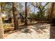 Spacious backyard featuring mature trees, a gravel ground cover, and a view of the home's exterior at 643 Edmonds Dr, Charleston, SC 29412