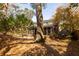 Lush backyard with mature trees and a view of the screened-in porch on the rear of the house at 643 Edmonds Dr, Charleston, SC 29412