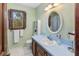 Cozy bathroom with mint green walls, a large oval mirror, and a colorful stained glass window at 643 Edmonds Dr, Charleston, SC 29412