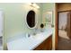This bathroom features an oval mirror, a blue countertop, and natural light from an open doorway at 643 Edmonds Dr, Charleston, SC 29412
