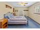 This bedroom boasts a ceiling fan, neutral walls, and a window with shutters for a cozy feel at 643 Edmonds Dr, Charleston, SC 29412