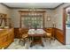 Charming breakfast nook featuring a sunny window, decorative wallpaper, and vintage wooden furniture at 643 Edmonds Dr, Charleston, SC 29412