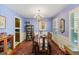 Traditional dining room with chandelier, china cabinet, and ample natural light from shuttered windows at 643 Edmonds Dr, Charleston, SC 29412