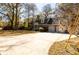 Lovely brick home with an attached two-car garage, surrounded by mature trees on a sunny day at 643 Edmonds Dr, Charleston, SC 29412