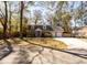 Inviting brick home with dormer windows, surrounded by mature trees and lush landscaping in a quiet neighborhood at 643 Edmonds Dr, Charleston, SC 29412