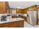 Well-lit kitchen with wood cabinetry, light countertops, stainless steel appliances, and a view to the dining area at 643 Edmonds Dr, Charleston, SC 29412