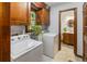 A charming laundry room features wood cabinetry, a stained glass window, and an entrance to a bathroom at 643 Edmonds Dr, Charleston, SC 29412