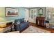 Cozy living room with hardwood floors, a comfortable sofa, and natural light from the windows at 643 Edmonds Dr, Charleston, SC 29412