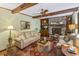 Spacious living room with exposed beams, brick fireplace, and comfortable seating arrangements at 643 Edmonds Dr, Charleston, SC 29412