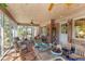 Cozy screened porch featuring brick flooring, wood ceiling, fan, and comfortable seating arrangement at 643 Edmonds Dr, Charleston, SC 29412