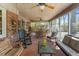 Inviting screened porch with ample seating, exposed brick and wood ceiling with ceiling fans for a relaxing atmosphere at 643 Edmonds Dr, Charleston, SC 29412