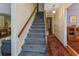 Carpeted staircase with wooden handrail, leading to the upper level of this well-maintained home at 643 Edmonds Dr, Charleston, SC 29412