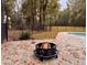 Outdoor retreat featuring a stone patio with pool and cozy fire pit at 6464 St Anthony Dr, Hollywood, SC 29449