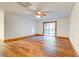 Finished basement space with wood-look floors, neutral walls, and sliding glass door to the outside at 6464 St Anthony Dr, Hollywood, SC 29449