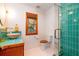 Charming bathroom featuring a turquoise tile shower, unique sink, and a window to the outdoors at 6464 St Anthony Dr, Hollywood, SC 29449