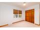 Bright bedroom featuring a ceiling fan, a window with blinds, and a wood closet door at 6464 St Anthony Dr, Hollywood, SC 29449