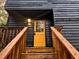 Exterior staircase leads to a bright yellow door on this unique home at 6464 St Anthony Dr, Hollywood, SC 29449