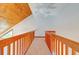 Long upstairs hallway featuring wood ceilings and wood railings with light carpet at 6464 St Anthony Dr, Hollywood, SC 29449