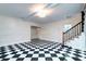 Bright living room with checkerboard floors, modern light fixture, staircase, and ample space at 6464 St Anthony Dr, Hollywood, SC 29449