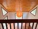 View looking down into the bright living room with wood ceiling, tile floors, and sliding glass doors at 6464 St Anthony Dr, Hollywood, SC 29449