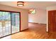 Bright living room with hardwood floors, a wood door, and sliding glass doors leading to the outside at 6464 St Anthony Dr, Hollywood, SC 29449
