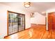 Bright living room with hardwood floors, a wood door, and sliding glass doors leading to the outside at 6464 St Anthony Dr, Hollywood, SC 29449