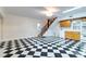 Spacious living room area with checkerboard floors, staircase, and modern light fixtures at 6464 St Anthony Dr, Hollywood, SC 29449