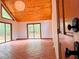 Bright living room with wood ceiling, tile floors, and sliding glass doors leading to the outside at 6464 St Anthony Dr, Hollywood, SC 29449