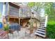 Spacious backyard featuring a stone patio, covered grill, and a staircase leading to the upper deck at 683 Edmonds Dr, Charleston, SC 29412