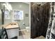 Well-lit bathroom features a shower with dark accent tile, and a vanity with modern fixtures at 683 Edmonds Dr, Charleston, SC 29412