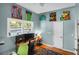 Bright bedroom featuring a desk, hardwood floors, and colorful animal-themed artwork adorning the walls at 683 Edmonds Dr, Charleston, SC 29412