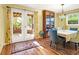 A dining room with hardwood floors and a view to the yard through a double door at 683 Edmonds Dr, Charleston, SC 29412