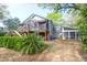 A beautiful exterior view of the home, complete with a large screened-in porch and an expansive backyard at 683 Edmonds Dr, Charleston, SC 29412